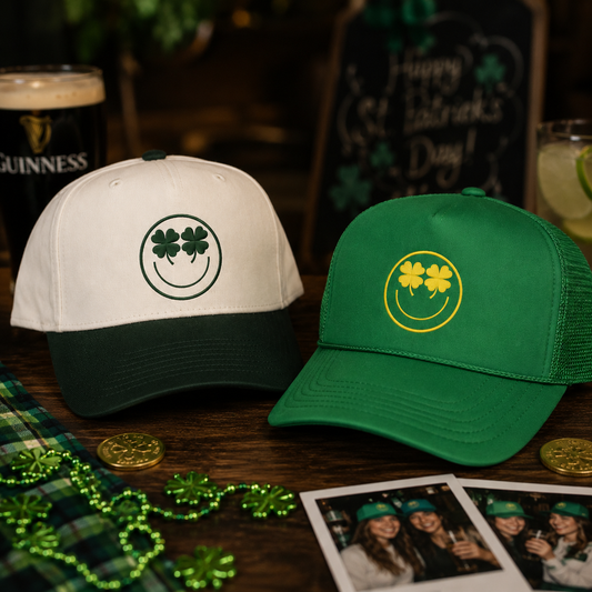 Two St. Patrick's Day trucker hats displayed on a wooden table with festive props.