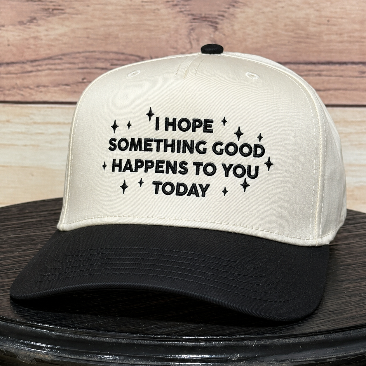 Natural and black embroidered baseball hat featuring "I Hope Something Good Happens to You Today" inspirational quote, structured trucker cap with premium embroidery and curved black brim.