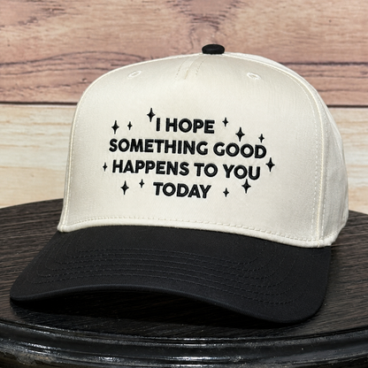 Natural and black embroidered baseball hat featuring "I Hope Something Good Happens to You Today" inspirational quote, structured trucker cap with premium embroidery and curved black brim.