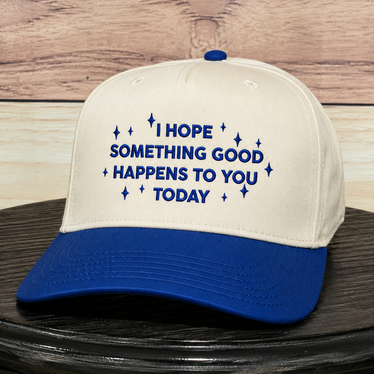 Cream and royal blue embroidered baseball hat featuring "I Hope Something Good Happens to You Today" inspirational quote, structured trucker cap with premium embroidery and curved blue brim.